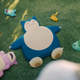 A real human observes Snorlax and sleeping Pokemon.